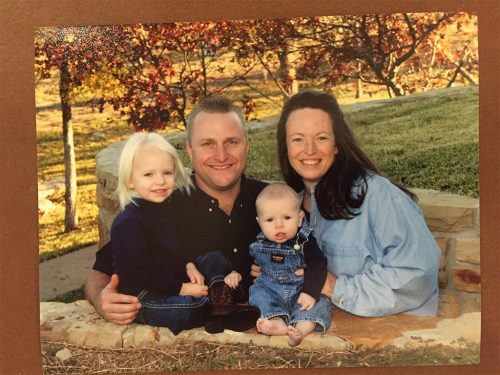 an image of Darryl with his wife and 2 small children taking a family photograph